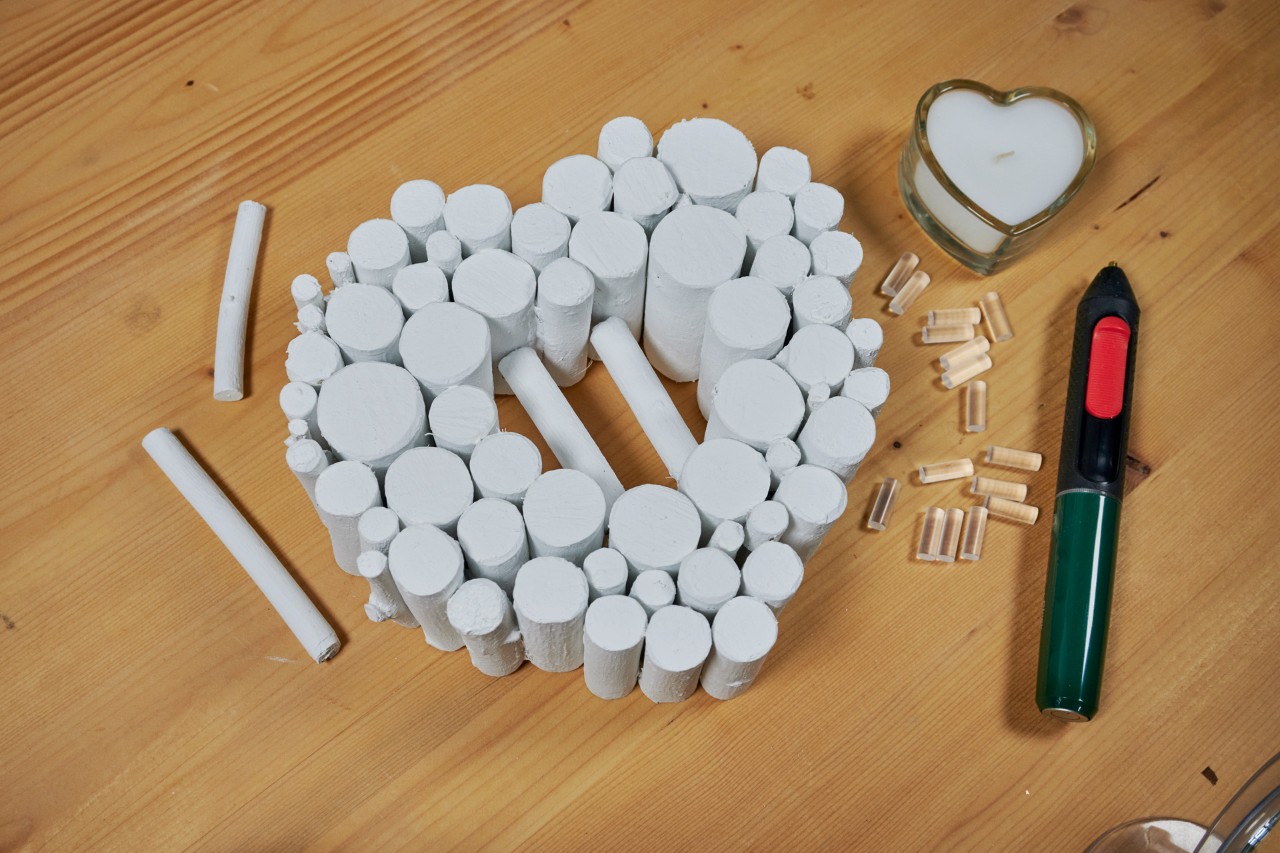 Crear un corazón de ramas: dos ramas pegadas en la abertura que sirven de plataforma para la vela.